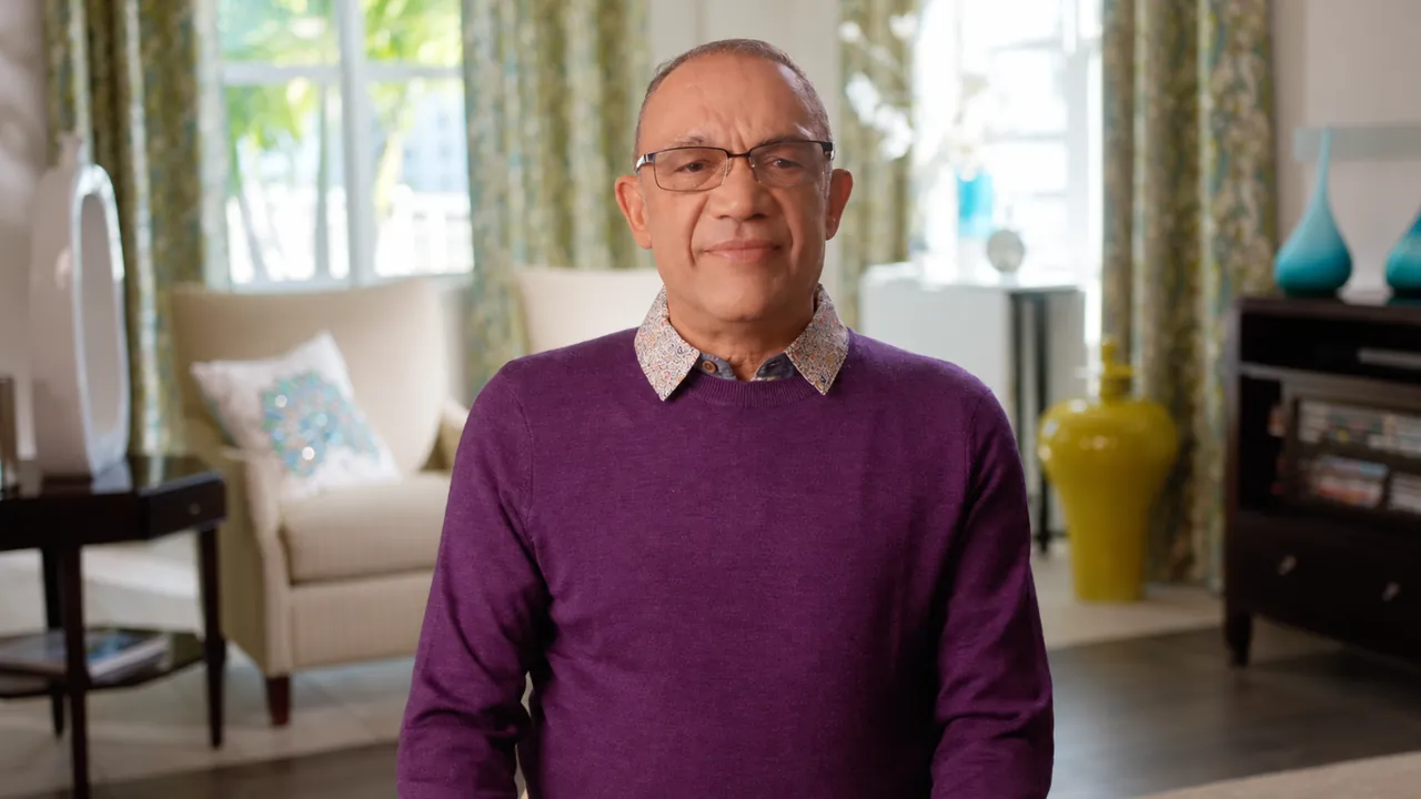 Tim with a subtle closed-mouth smile during his patient interview
